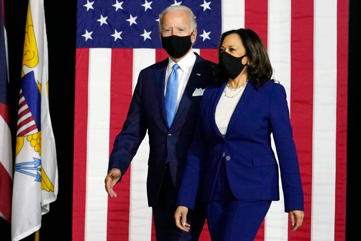 Then Democratic presidential candidate Joe Biden and his running mate Sen. Kamala Harris (D-Calif.) arrive to speak at a news conference at Alexis Dupont High School in Wilmington, Del., on Aug. 12, 2020. (Carolyn Kaster/AP Photo)