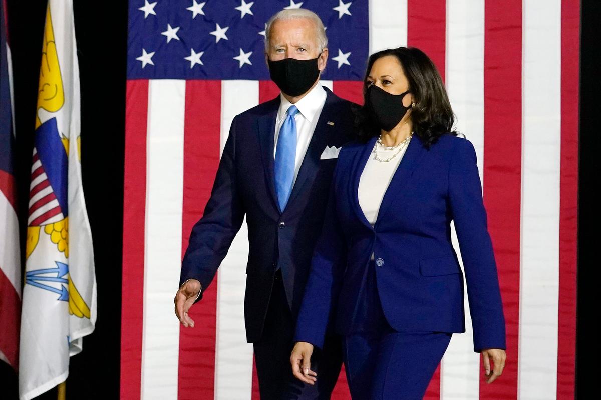 Democratic presidential candidate Joe Biden and his running mate Sen. Kamala Harris (D-Calif.) arrive to speak at a news conference at Alexis Dupont High School in Wilmington, Del., on Aug. 12, 2020. (Carolyn Kaster/AP Photo)