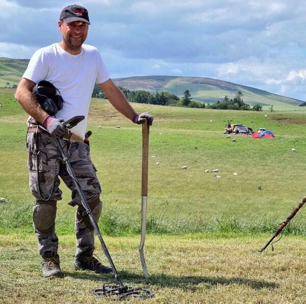 Metal detectorist Mariusz Stepien at the excavation site near Peebles, after he found objects believed to be from the Bronze Age objects, in Scotland, in an undated photo. (Crown Office Communications via AP)