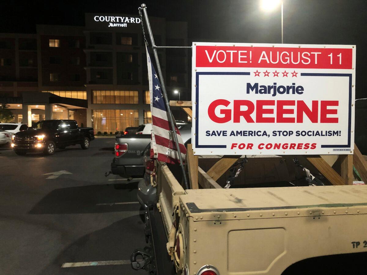 A sign showing support for Marjorie Taylor Greene is seen on a vehicle outside an election watch event, in Rome, Ga., on Aug. 11, 2020. (Mike Stewart/AP Photo)