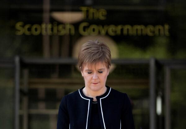Scotland's First Minister Nicola Sturgeon observes a minute of silence in a tribute to the NHS staff and key workers who died during the coronavirus disease (COVID-19) outbreak, outside St Andrew's House in Edinburgh, on Apr. 28. 2020. (Jane Barlow/Pool via Reuters)