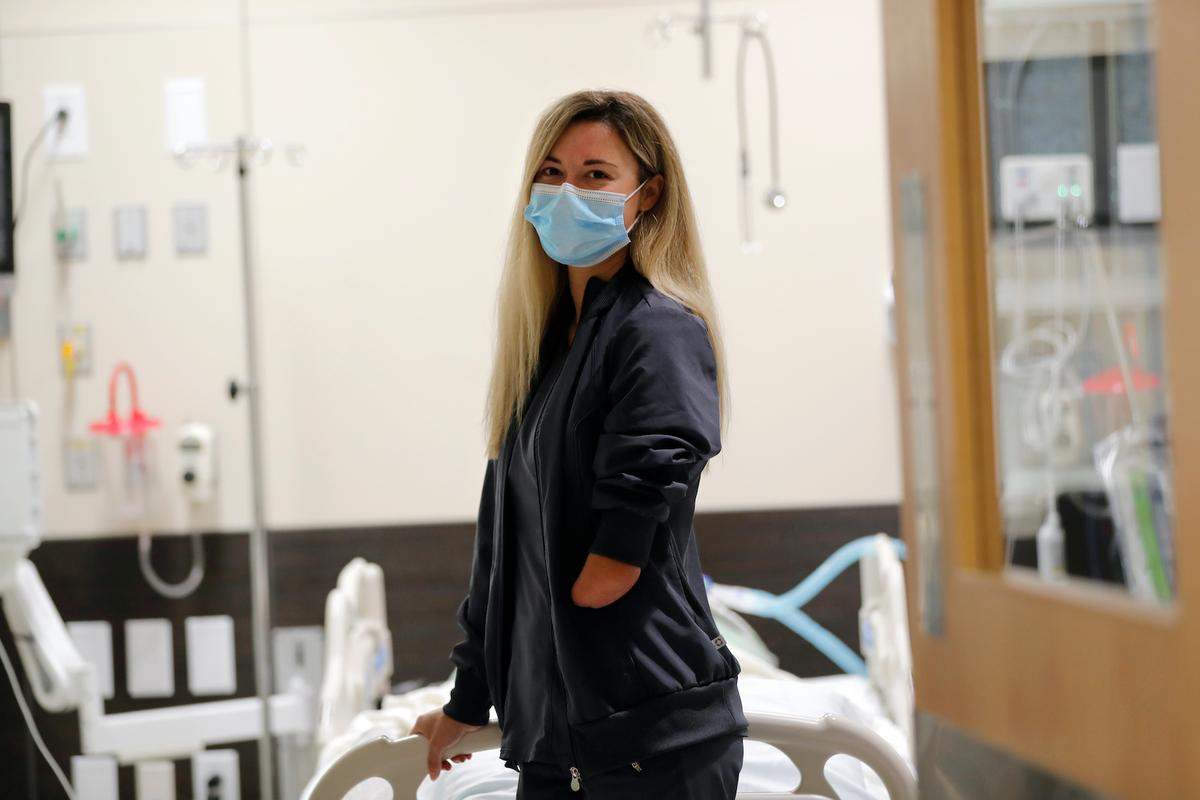 Respiratory therapist Savannah Stuard, who was born without a left forearm, poses inside a simulation lab at Ochsner Hospital in New Orleans on July 28, 2020. (Gerald Herbert/AP)