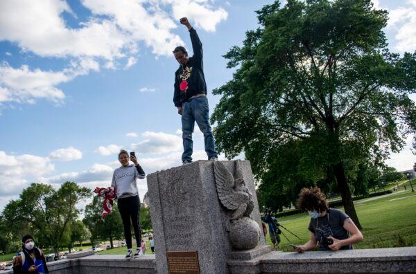 A man stands where a statue of Christopher Columbus was toppled by vandals on the grounds of the state Capitol in St. Paul, Minn., on June 10, 2020. (Stephen Maturen/Getty Images)