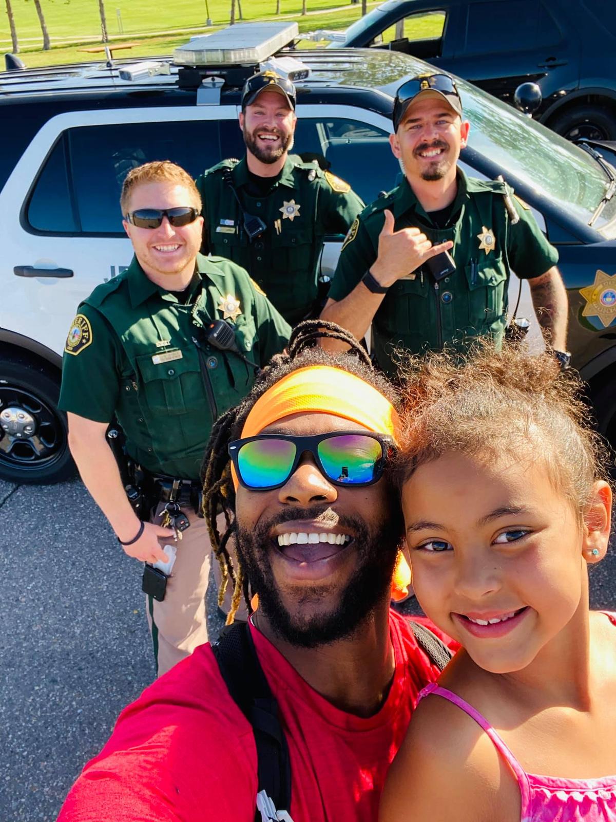 Donnell, daughter Luna, and three sheriff's officers (Courtesy of <a href="https://www.facebook.com/dj.goss">Donnell Goss</a>)
