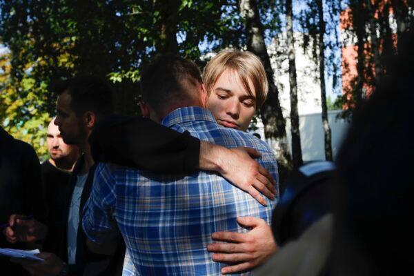 People hug after being released from a detention center in Minsk, Belarus, on Aug. 14, 2020. (Sergei Grits/AP Photo)