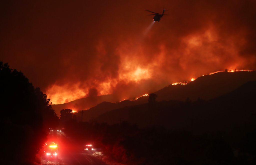 A firefighting helicopter (TOP) flies over the Lake Fire on Aug. 12, 2020, in Lake Hughes, Calif. (Mario Tama/Getty Images)