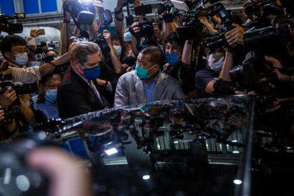 Hong Kong pro-democracy media mogul Jimmy Lai (C) pushes through a media pack to get to a waiting vehicle after being released on bail from the Mong Kok police station in the early morning in Hong Kong on August 12, 2020, after the Apple Daily founder was arrested under the new national security law. (Isaac Lawrence/AFP via Getty Images)