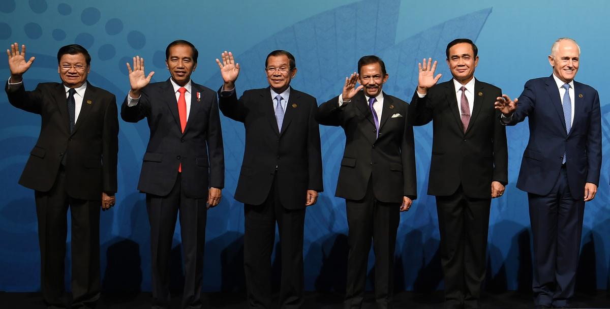Australia's Prime Minister Malcolm Turnbull (R) waves with ASEAN leaders (L to 2nd R) Laos' Prime Minister Thongloun Sisoulith, Indonesia's President Joko Widodo, Cambodia's Prime Minister Hun Sen, Brunei's Sultan Hassanal Bolkiah and Thailand's Prime Minister Prayuth Chan-O-Cha for a family picture at the ASEAN-Australia Special Summit in Sydney on March 17, 2018. (Saeed Khan/AFP via Getty Images)