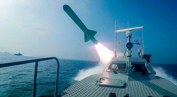 In this photo released Tuesday, July 28, 2020, by Sepahnews, a Revolutionary Guard's speed boat fires a missile during a military exercise. Iranian commandos also fast-roped down from a helicopter onto a replica of an aircraft carrier in the exercise called "Great Prophet 14." (Sepahnews via AP)