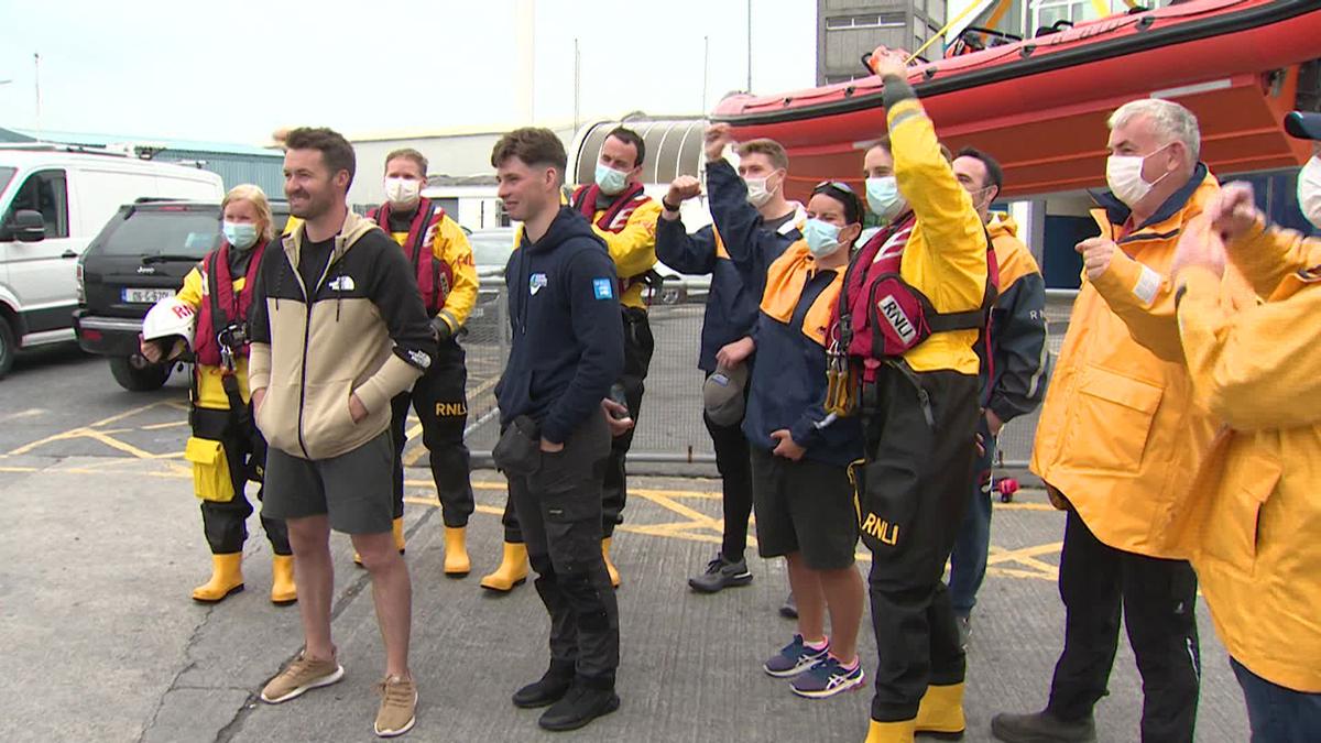 Patrick Oliver and his son Morgan, who rescued two paddleboarders 20 miles off Galway, stand with Royal National Lifeboat Institution (RNLI) members at Galway Docks. (Courtesy of Virgin Media Ireland)