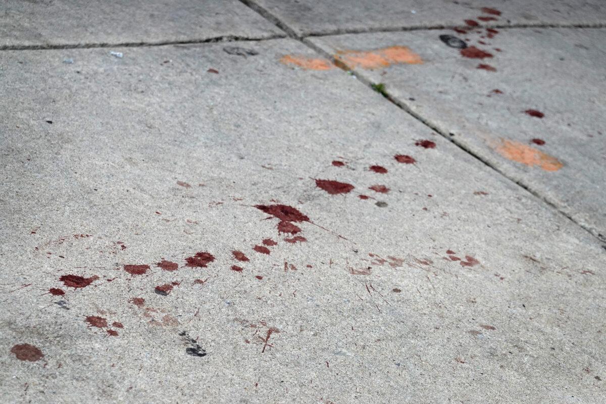 A trail of blood leads away from the shattered glass door of a Bloomingdales store that was looted in Chicago on Aug. 10, 2020. (Scott Olson/Getty Images)