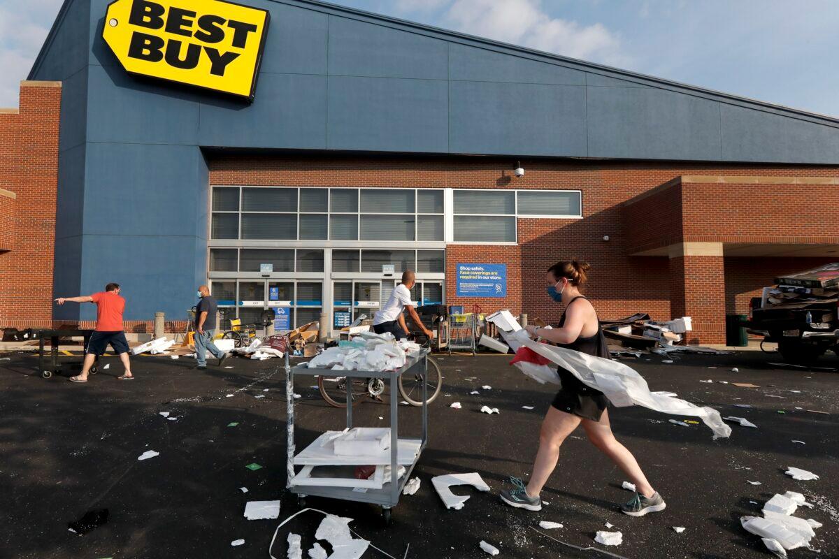 Volunteers help clean up the parking lot outside a Best Buy store in Chicago on Aug. 10, 2020. (Charles Rex Arbogast/AP Photo)