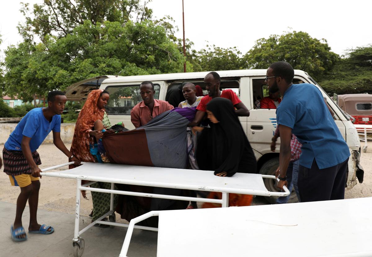 Civilians assist an injured person at Madina hospital after a blast at the Elite Hotel in Lido beach in Mogadishu, Somalia, on Aug. 16, 2020. (Reuters/Feisal Omar)