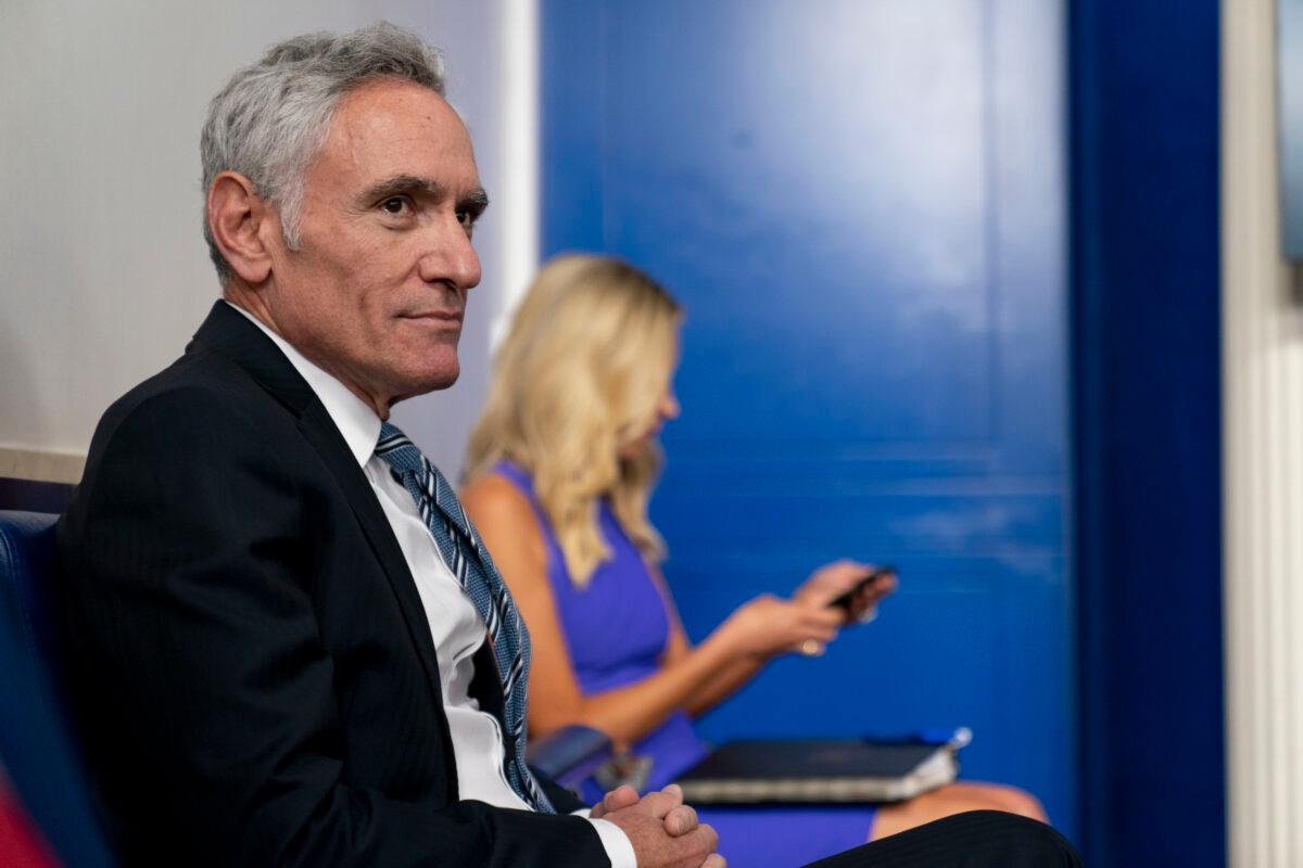 Scott Atlas (L), a senior fellow at the Hoover Institution, and White House press secretary Kayleigh McEnany arrive ahead of President Donald Trump for a press conference at the White House in Washington on Aug. 12, 2020. (Andrew Harnik/AP Photo, File)