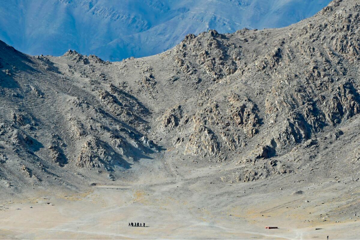 Indian soldiers walk at the foothills of a mountain range near Leh, the joint capital of the union territory of Ladakh, on June 25, 2020. Indian fighter jets roared over a flashpoint Himalayan region on June 24 as part of a show of strength following what military sources say has been a Chinese takeover of contested territory. (TAUSEEF MUSTAFA/AFP via Getty Images)
