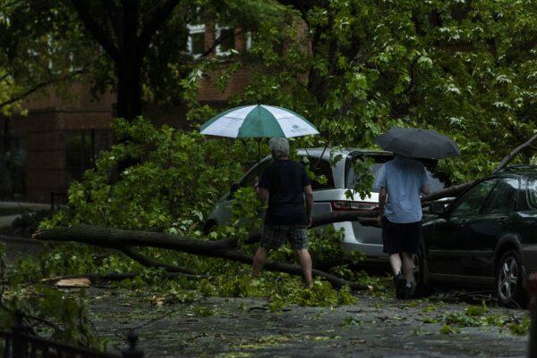 Two men survey the damage to their cars after a severe thunderstorm battered Chicago neighborhoods on Aug. 10, 2020. (Tyler LaRiviere/Sun-Times/Chicago Sun-Times via AP)