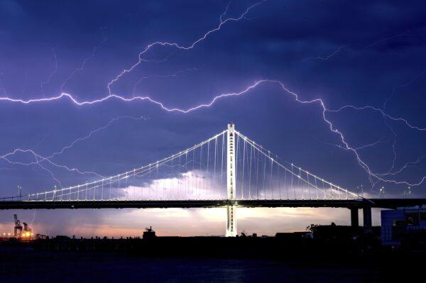 Lightning forks over the San Francisco-Oakland Bay Bridge as a storm passes over Oakland, Calif., on Aug. 16, 2020. (Noah Berger/AP Photo)