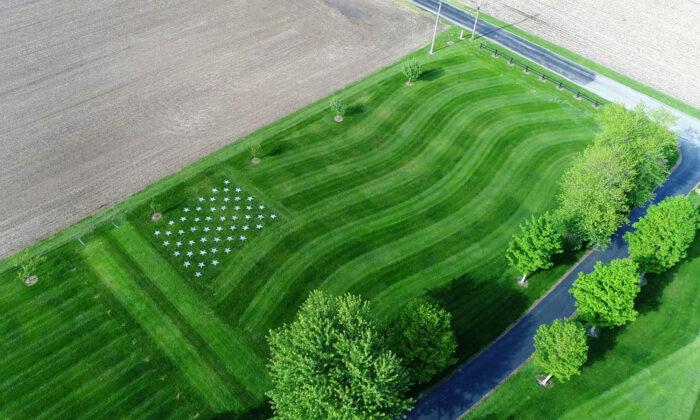 Coach Mows Giant US Flag in Lawn to Honor Fallen Soldier, a Former Wrestling Student