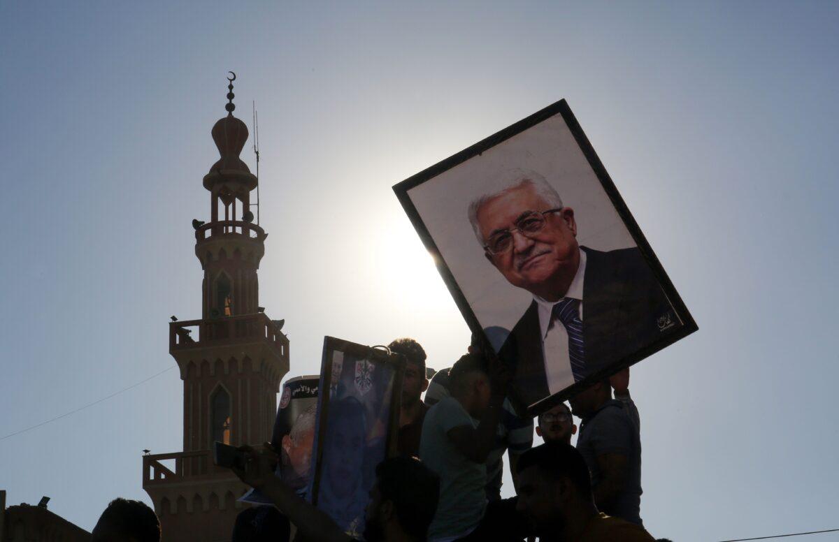 Protesters hold a portrait of Palestinian President Mahmud Abbas during a demonstration against Israel's West Bank annexation plans, in the Gaza Strip on July 2, 2020. (Said Khatib/AFP via Getty Images)