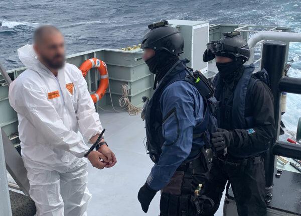 Law enforcement authorities arrest members of the Coralynne's crew on Aug. 15, 2020. (Australian Federal Police)