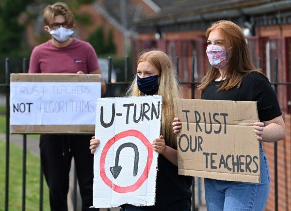 Students hold placards as they protest outside Codsall Community High School to demonstrate against the downgrading of A-level results near Wolverhampton, central England, on Aug.17, 2020. (Paul Ellis/AFP via Getty Images)