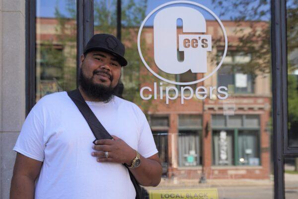 Chris Schmidt, a barber at Gee's Clippers, stands outside his workplace in the Bronzeville neighborhood of Milwaukee, Wis., on Aug. 4, 2020. (Cara Ding/The Epoch Times)