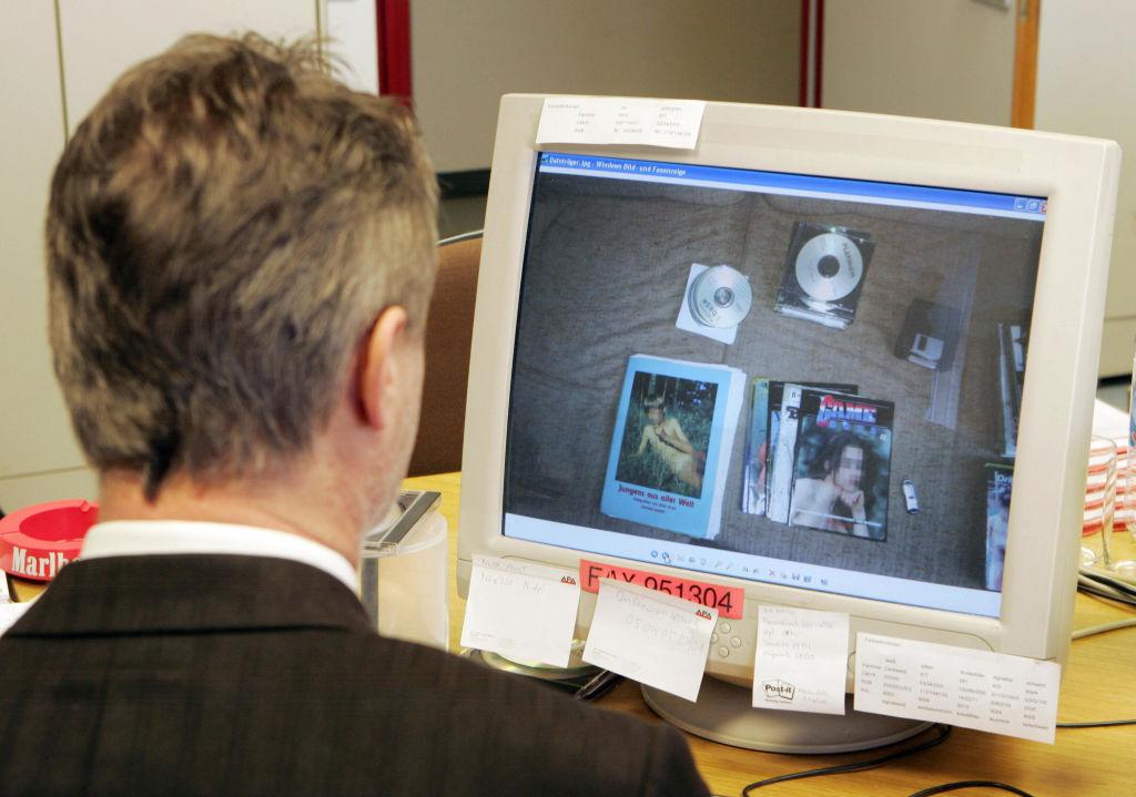 A police officer reviews computer data in conjunction with the legal act "Sledgehammer" against worldwide child pornography in Vienna, Austria, on March 13, 2009 (DIETER NAGL/AFP via Getty Images)