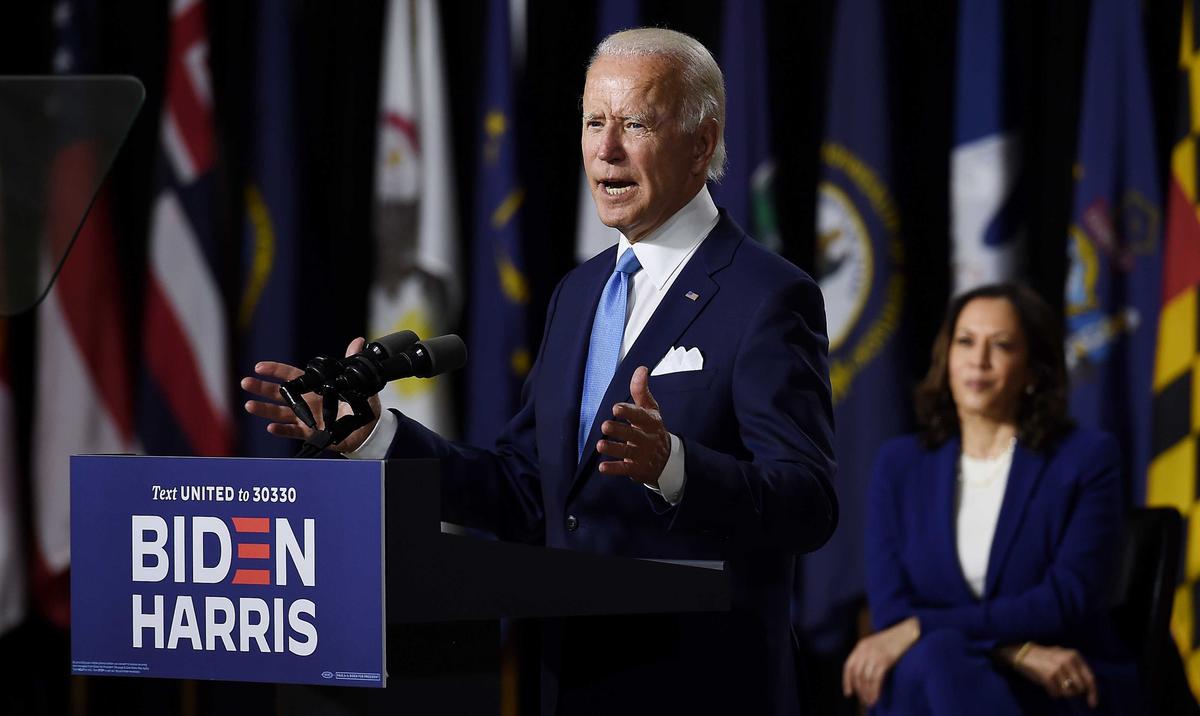 Democratic presidential nominee and former Vice President Joe Biden speaks as his vice presidential running mate, Sen. Kamala Harris, listens during their first press conference in Wilmington, Del., on Aug. 12, 2020. (Olivier Douliery/AFP via Getty Images)