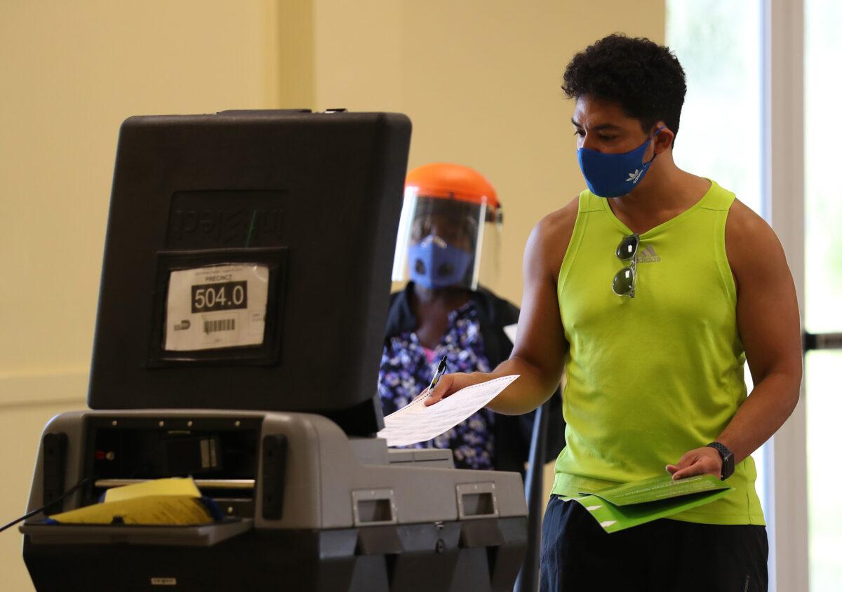 Ron Bilbao casts his vote on primary election day in Miami, Fla., on Aug. 18, 2020. (Joe Raedle/Getty Images)