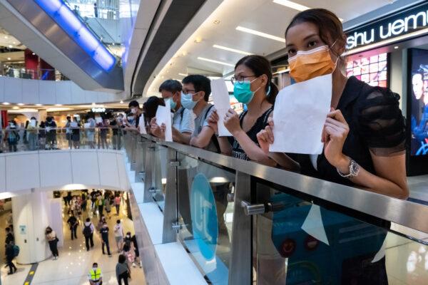 Protesters hold up blank papers during a demonstration in a mall in Hong Kong, on July 6, 2020. Hongkongers are finding creative ways to voice dissent as police began making arrests for people displaying now forbidden political slogans. (Billy H.C. Kwok/Getty Images)