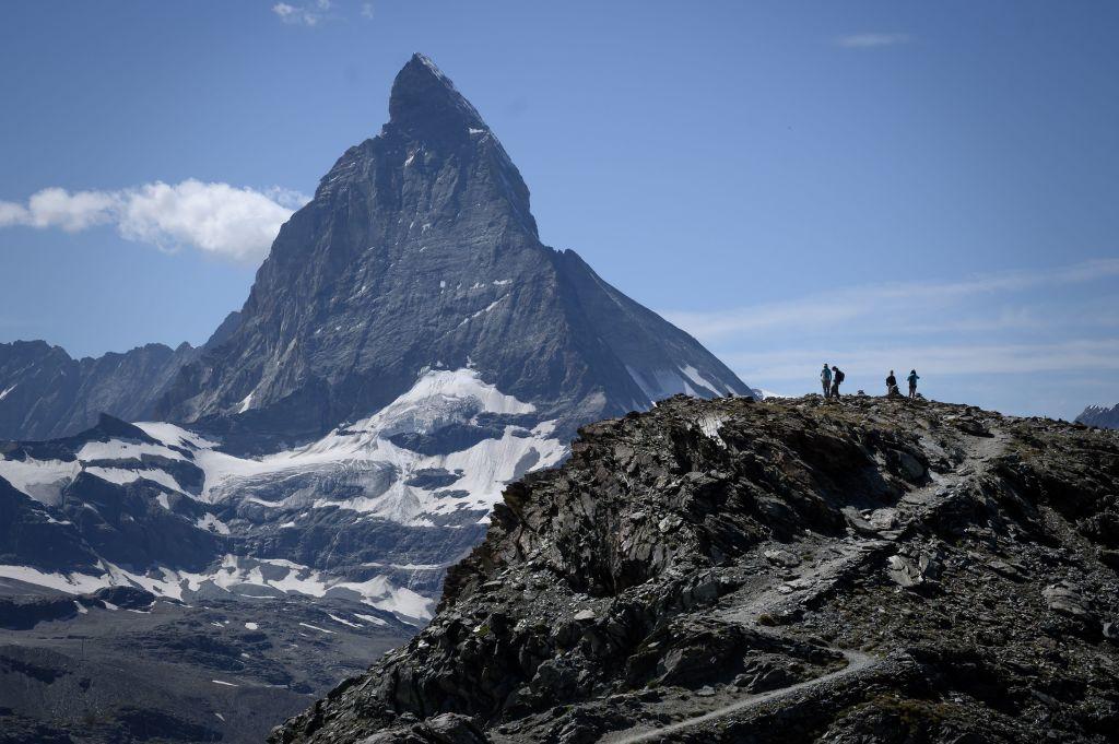 Hikers stand in front of the Matterhorn mountain above the resort of Zermatt, Switzerland, as a heatwave sweeps Europe on Aug. 8, 2020 (FABRICE COFFRINI/AFP via Getty Images)