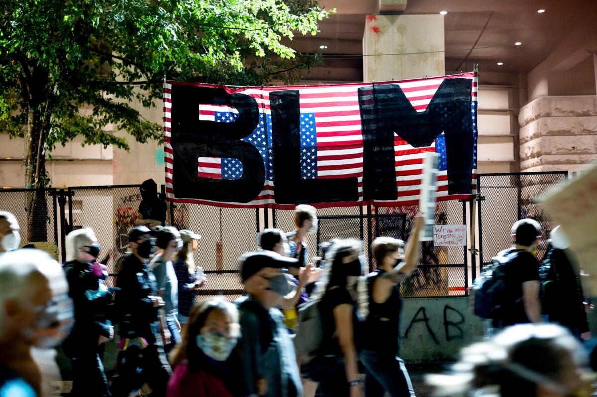 Black Lives Matter protesters march past the Mark O. Hatfield United States Courthouse in Portland, Ore., in a July 31, 2020, file photograph. (Noah Berger/AP Photo)