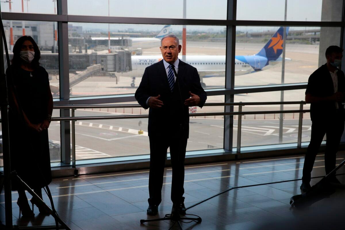 Israeli Prime Minister Benjamin Netanyahu, center, and Transportation Minister Miri Regev, left, tour Ben-Gurion Airport and are briefed on preparations for the resumption of flights between Israel and the UAE, southeast of Tel Aviv, on Aug. 17, 2020. (Emil Salman/Haaretz/Pool via AP)