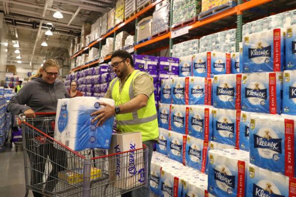 Staff members assist shoppers at Costco Perth on March 19, 2020 in Perth, Australia. (Paul Kane/Getty Images)