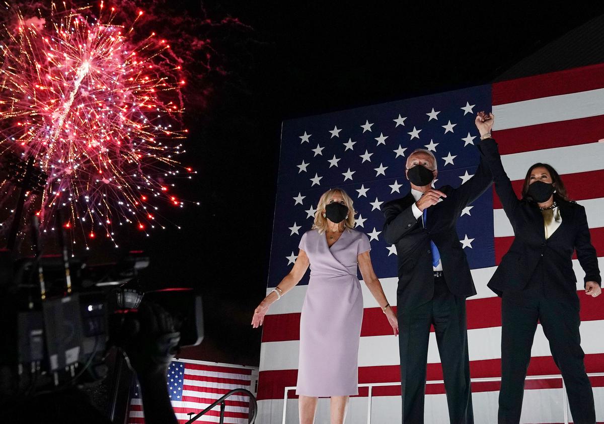 (From L) Jill Biden, husband former vice-president and Democratic presidential nominee Joe Biden and Senator from California and Democratic vice presidential nominee Kamala Harris greet supporters outside the Chase Center in Wilmington, Delaware, at the conclusion of the Democratic National Convention, held virtually amid the novel coronavirus pandemic, on Aug. 20, 2020. (Olivier Douliery/AFP via Getty Images)