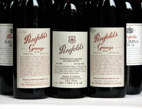 A Penfolds 1962 vintage Cabernet Shiraz (C), voted number seven in a list of 100 of the world's greatest ever wines, is flanked (L and R) by 1991 vintage bottles of the famous Penfolds Grange red wine, at a special re-corking clinic in Sydney, 12 July 2006. (Greg Wood/AFP via Getty Images)