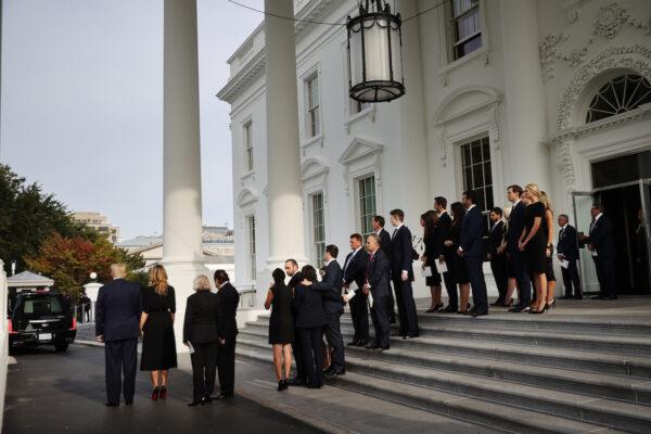 President Donald Trump (L) and first lady Melania Trump are joined by members of the Trump family as Robert Trump's casket is driven away in a hearse at the North Portico of the White House following his funeral service in Washington on Aug. 21, 2020. (Chip Somodevilla/Getty Images)