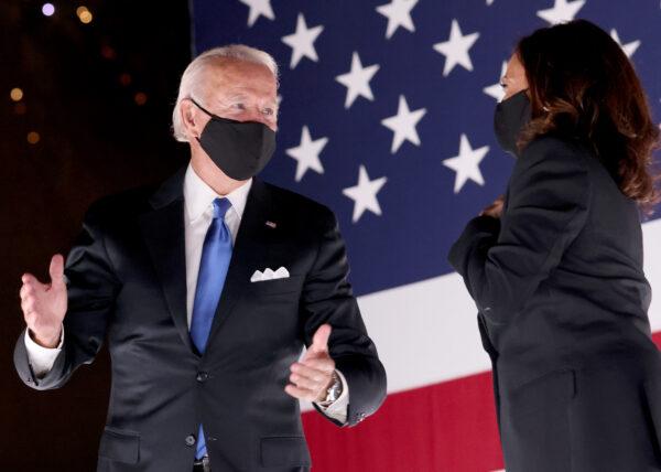 Democratic presidential nominee Joe Biden speaks to vice presidential nominee Sen. Kamala Harris (D-Calif.) on stage outside the Chase Center in Wilmington, Del., on Aug. 20, 2020. (Win McNamee/Getty Images)