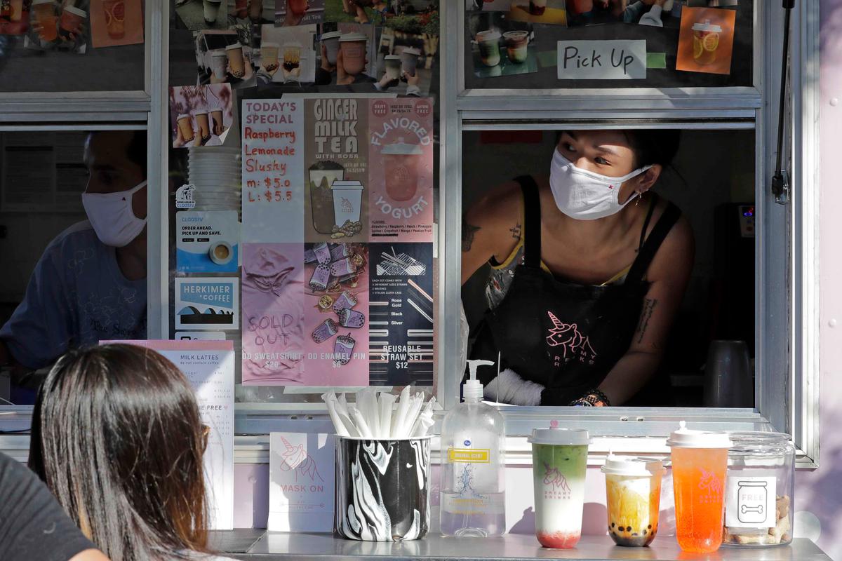 Kaye Fan, right, calls out orders as she works in her Dreamy Drinks food truck, Monday, Aug. 10, 2020, near the suburb of Lynnwood, Wash., north of Seattle. (Ted S. Warren/AP)