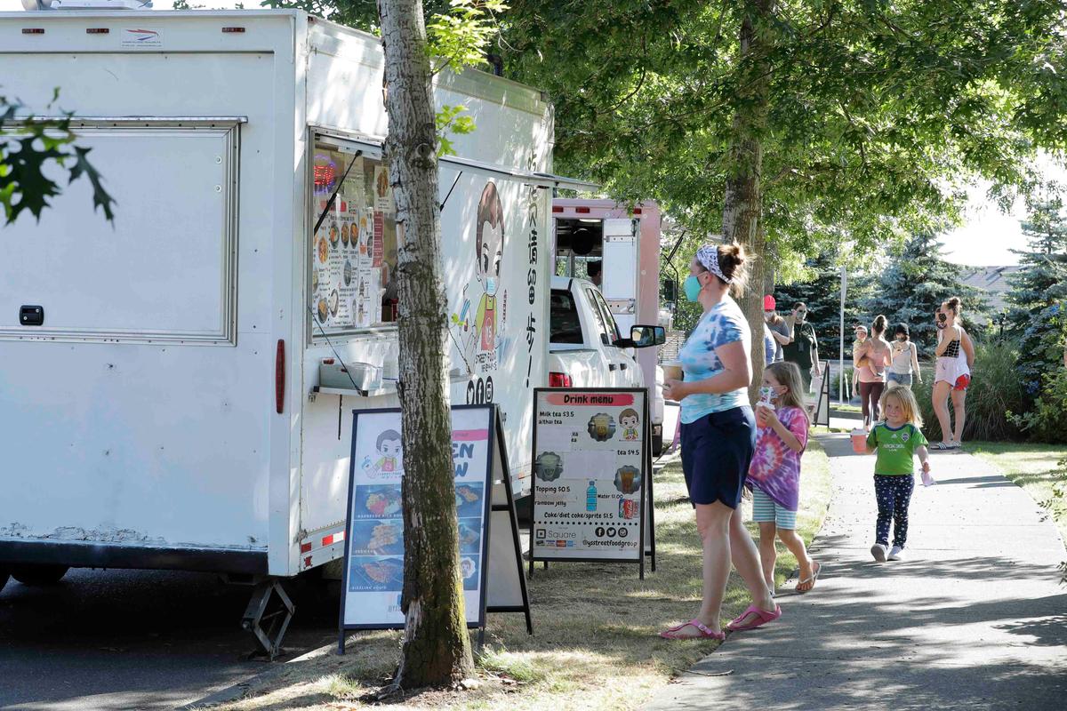 Customers line up to order from the YS Street Food food truck, Monday, Aug. 10, 2020, near the suburb of Lynnwood, Wash., north of Seattle. (Ted S. Warren/AP)