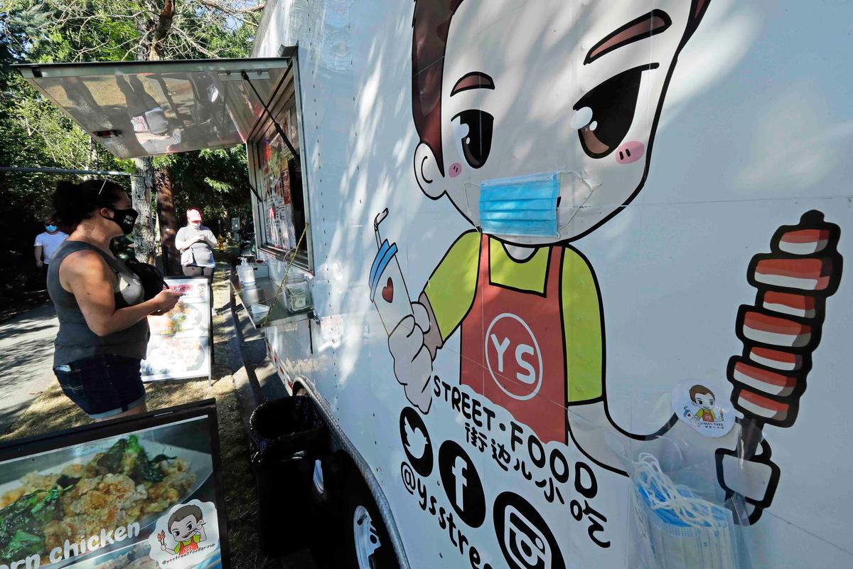 A customer orders from the YS Street Food food truck, Monday, Aug. 10, 2020, near the suburb of Lynnwood, Wash., north of Seattle. (Ted S. Warren/AP)