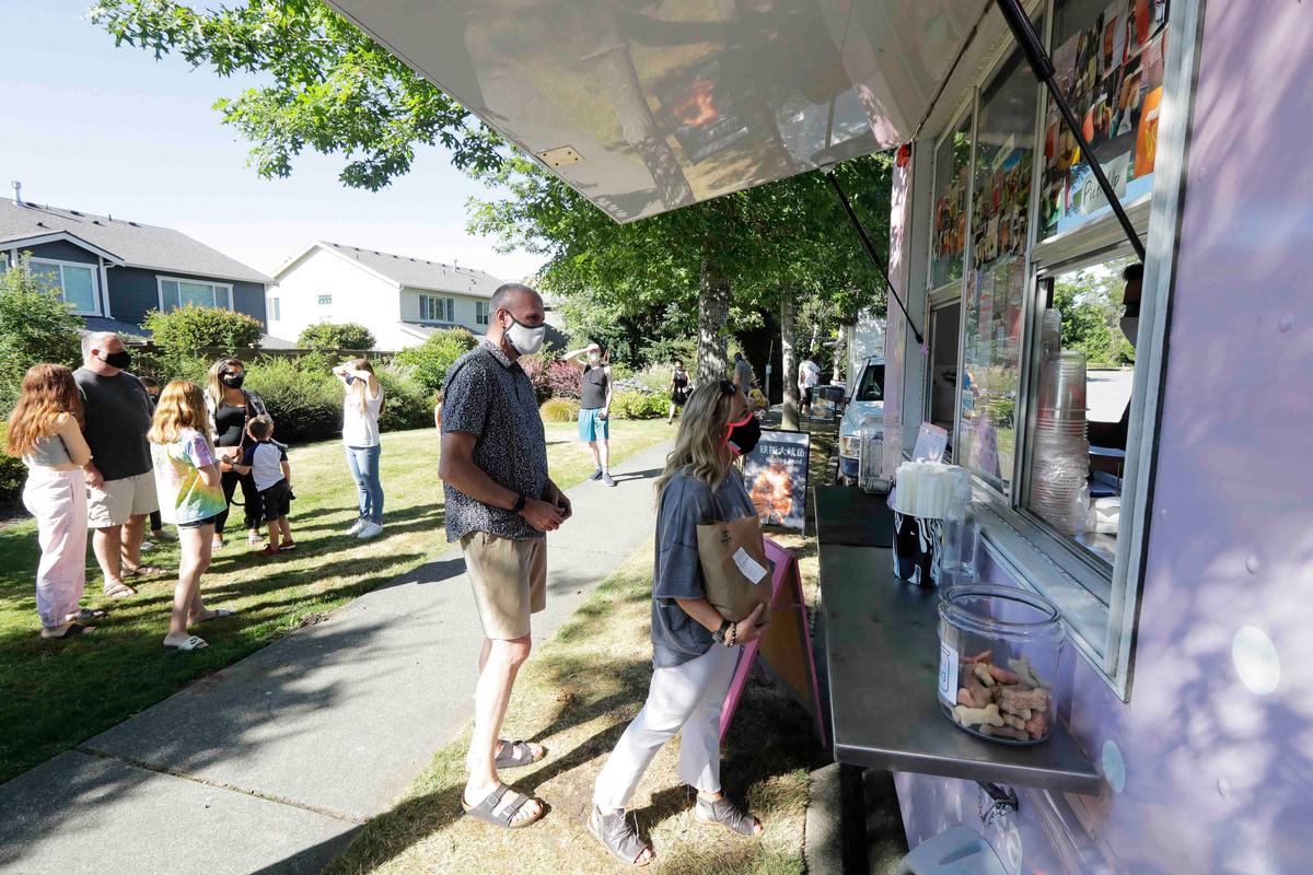 Julie and Greg Schwab wait to order from the Dreamy Drinks food truck, Monday, Aug. 10, 2020, near the suburb of Lynnwood, Wash., north of Seattle. (Ted S. Warren/AP)