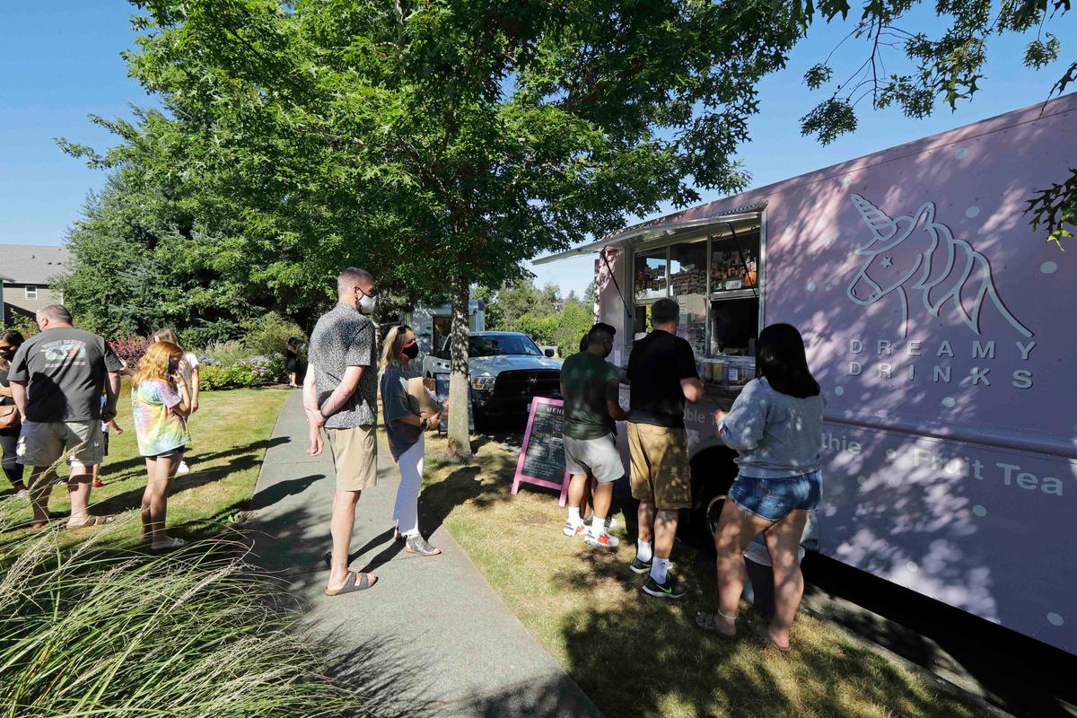 Customers line up to order from the Dreamy Drinks food truck, Monday, Aug. 10, 2020, near the suburb of Lynnwood, Wash., north of Seattle. (Ted S. Warren/AP)