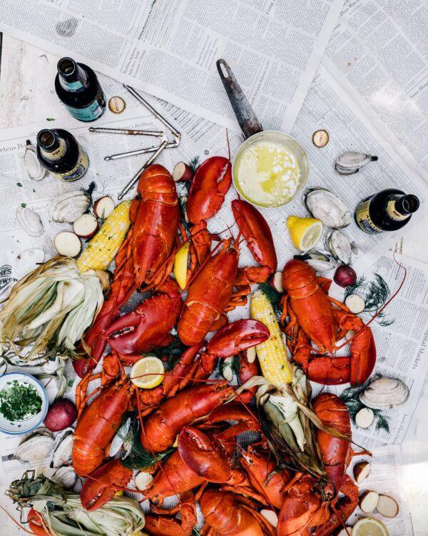 Serve your steamed seafood feast with plenty of drawn butter, cold drinks, and good company. (Allagash Brewing via Flickr/CC BY 2.0)