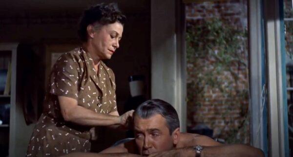 Nurse Stella (Thelma Ritter) gives her patient “Jeff” Jefferies (James Stewart) a massage, in “Rear Window.” (Paramount Pictures)