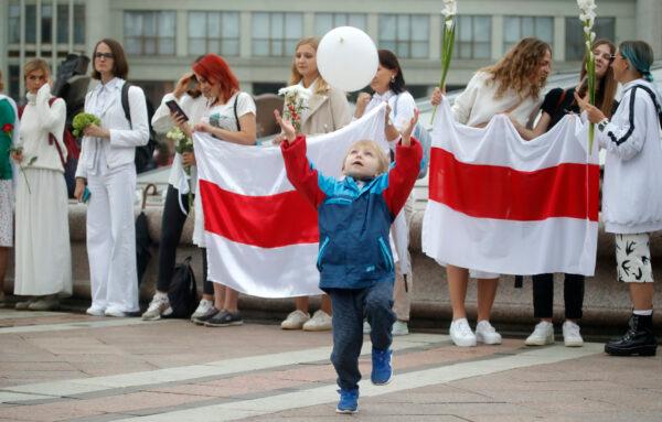 A young boy catches a balloon during a protest in Minsk on Aug. 23, 2020. (Dmitri Lovetsky/AP Photo)