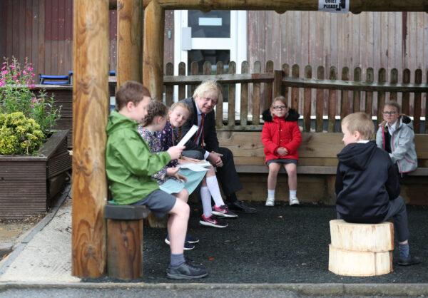 Prime Minister Boris Johnson joins a socially distanced lesson during a visit to Bovingdon Primary School, near Hemel Hempstead, on June 19, 2020. (Steve Parsons - WPA Pool/Getty Images)