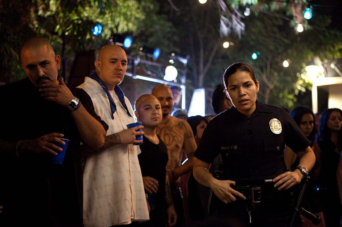 America Ferrera (Front, R) investigates a homicide as L.A. Latino gang members look on, in "End of Watch." (Scott Garfield/Open Road Films)