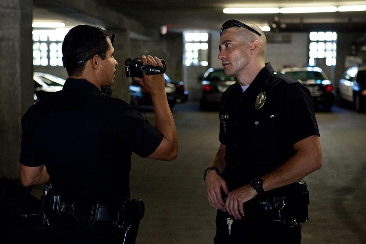 Michael Peña (L) and Jake Gyllenhaal shoot footage of their cop lives in "End of Watch." (Scott Garfield/Open Road Films)