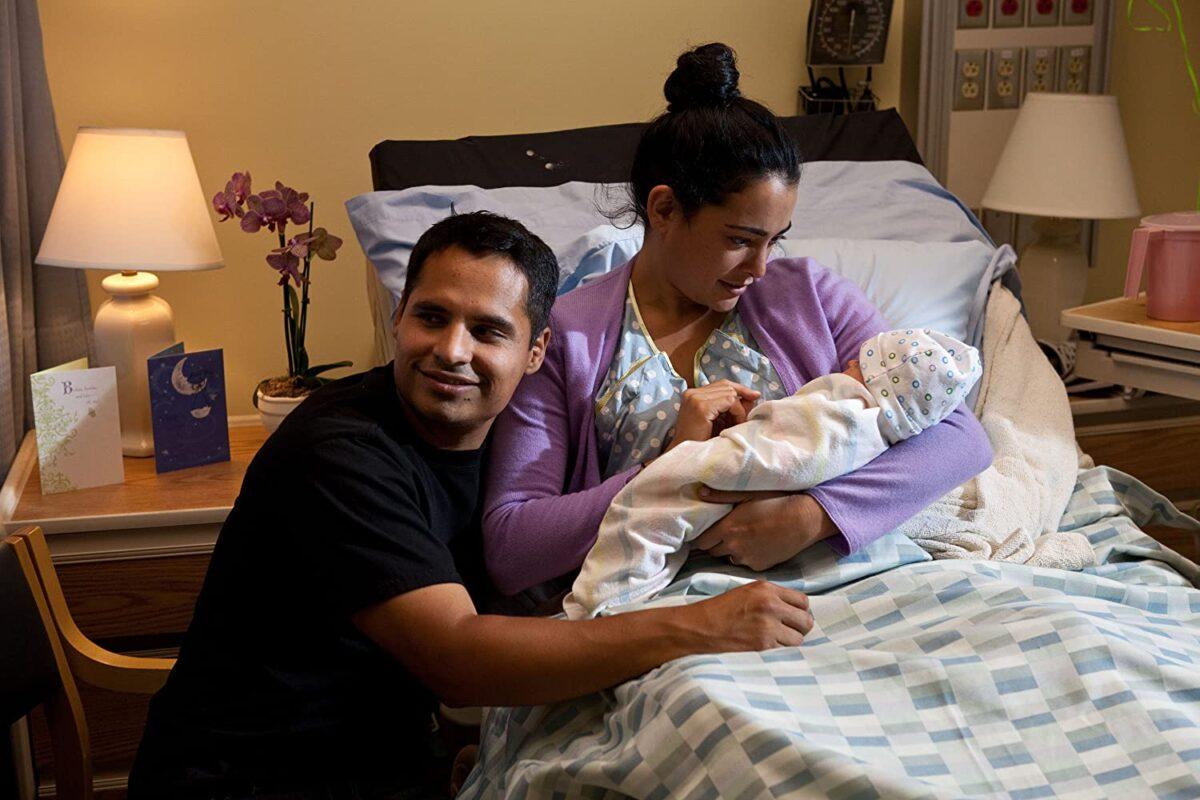 Michael Peña and Natalie Martinez as husband and wife welcoming their firstborn in "End of Watch." (Scott Garfield/Open Road Films)